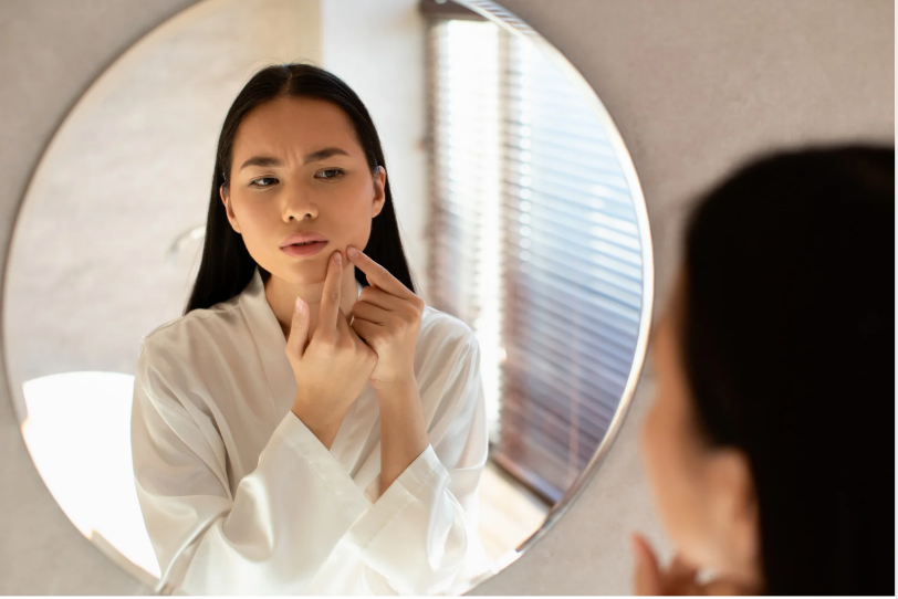 woman looking at mirror