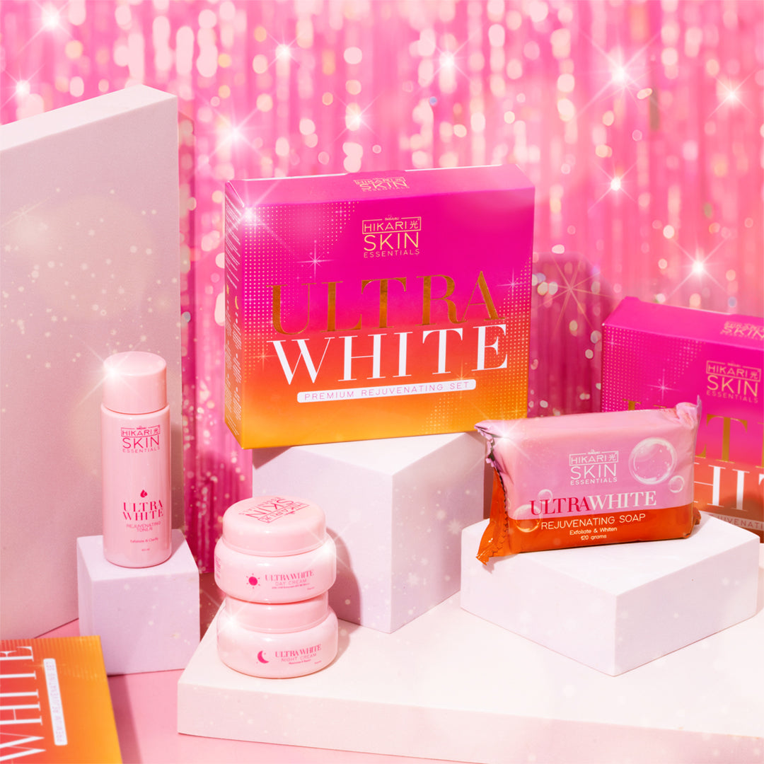 Skincare products with 'Ultra White' packaging on a pink glittery background